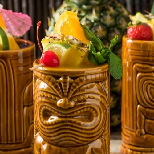 drinks in tiki mugs with fruit