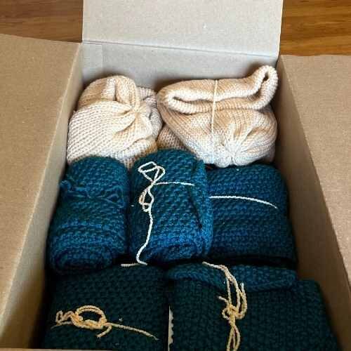 box of knitted scarves and beanies